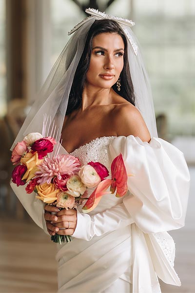 Veronica's wedding dress features a Juliet sleeve style