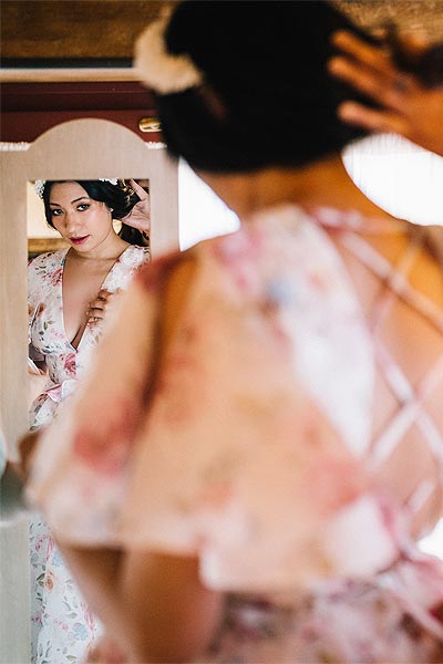 Samantha posing in the mirror in her custom wedding dress