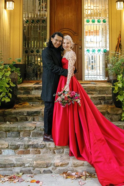 Sunny posing with Eduardo in her custom red wedding dress