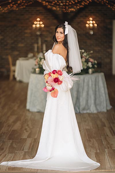 Veronica posing in her custom wedding gown