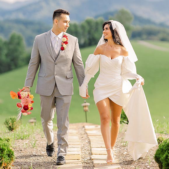 Veronica walking in her custom wedding dress with Nick