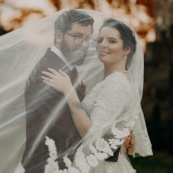 Kiki in her custom wedding dress posing with Eric