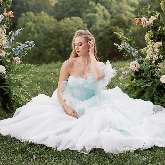 Payton sitting in her custom wedding gown