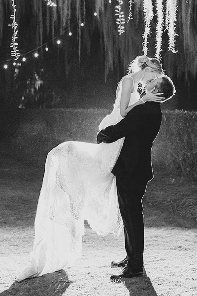 Erin jumping into her groom's arms at their reception.