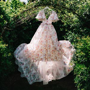 Samantha's floral wedding dress hanging among the tress.