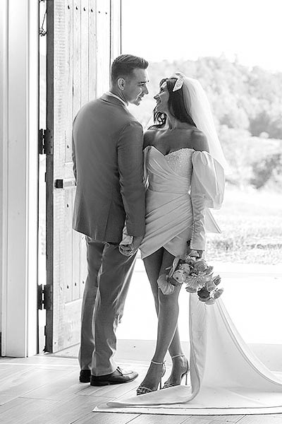 Veronica and nick posing for a bridal portrait in a doorway.