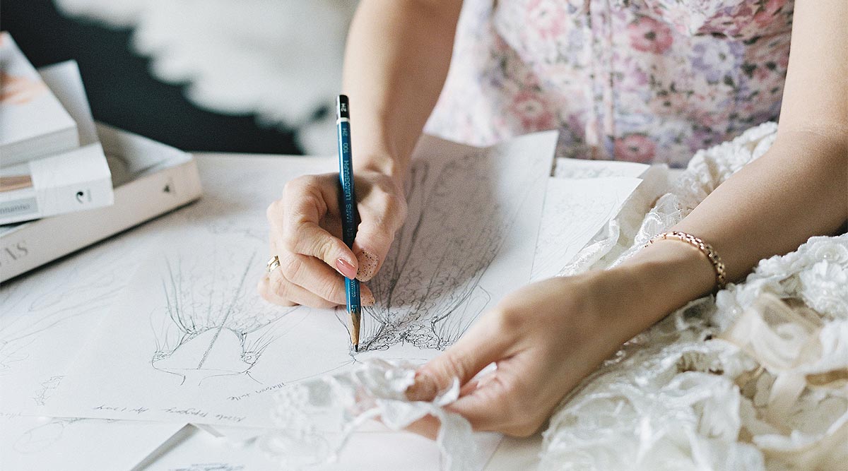 Angela sketching a custom wedding dress.