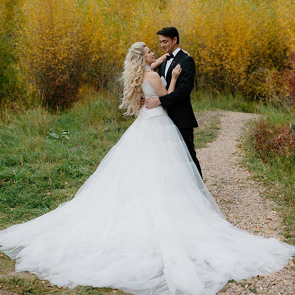 Kaitlin in her custom wedding gown posing with William.