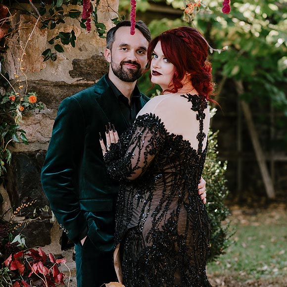 Katie posing in her custom beaded black lace wedding gown