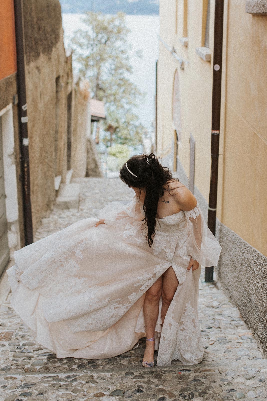 Morgan posing on an Italian alleyway in her one of a kind wedding dress